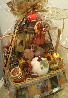 a basket filled with lots of different types of food and decorations on top of a table