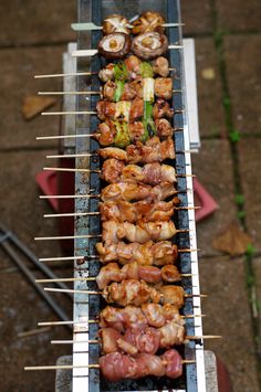 the skewers are being prepared to be cooked on the bbq grills