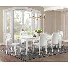 a white dining room table and chairs