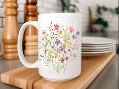 a white coffee mug sitting on top of a wooden tray