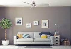 a living room filled with furniture and pictures on the wall