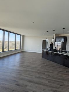 an empty living room with wood floors and large windows looking out onto the desert outside