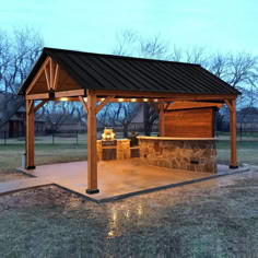 a covered outdoor grill area with lights on