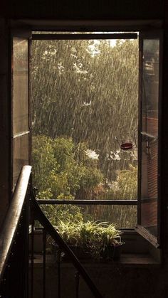 an open window with rain coming in from the outside