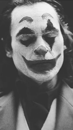 black and white photograph of a man with clown makeup