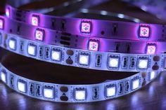 two purple and white leds on a wooden table