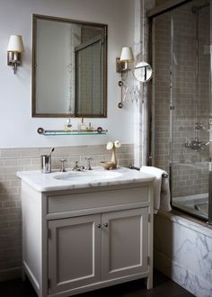 a bathroom with two sinks and a shower