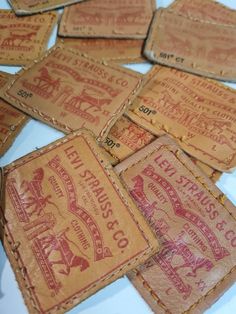 old stamps are laid out on the table to be used as coasters or wall hangings