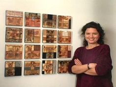 a woman standing in front of a wall with many pictures on it