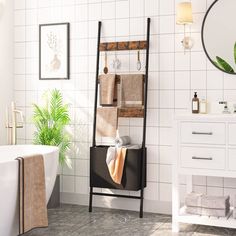 a bath room with a tub a mirror and a plant on the wall in it