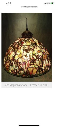 a lamp that is sitting on top of a table with the words, 28 magnolia shade - created in 2003