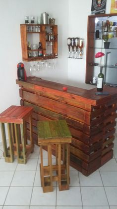 a bar made out of wooden pallets with stools