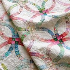 a close up view of a quilt with circles on it