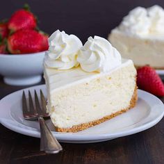 two slices of cheesecake with whipped cream and strawberries