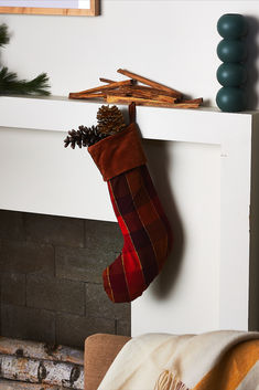 a christmas stocking hanging from a fireplace mantel