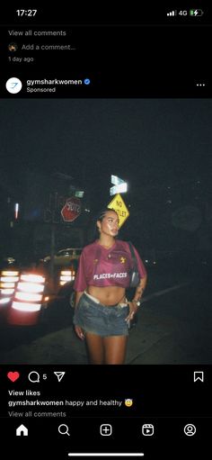 a woman standing in the street at night