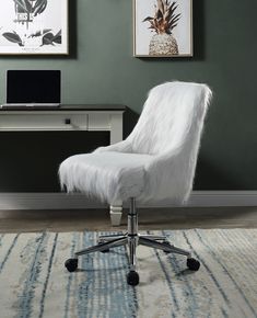 a white chair sitting on top of a rug in front of a desk with a computer