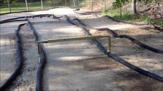 an empty skateboard park with ramps in the middle and no people around it at all