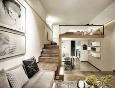 a living room filled with furniture next to a staircase leading up to a loft bed