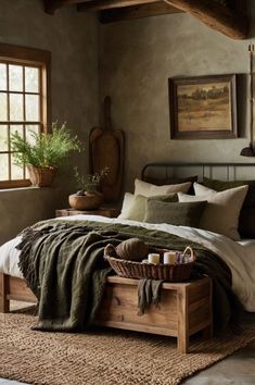 a bedroom with a large bed and lots of pillows on the floor next to a window