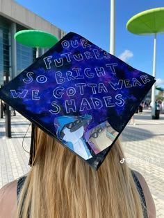 a woman wearing a graduation cap with writing on it