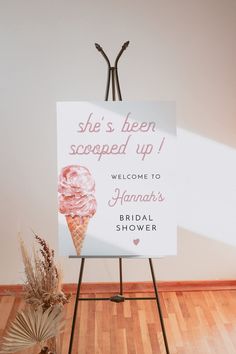 a sign that is on top of a easel with flowers in front of it and the words, she's been scapped up welcome to hannahs bridal shower