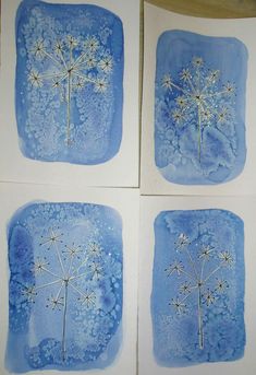 four blue and white paintings with flowers on them