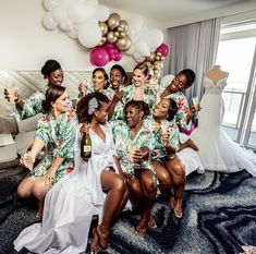 a group of women posing for a photo in front of some balloons and champagne bottles