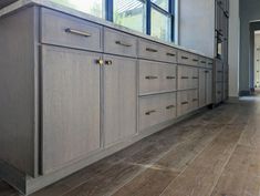 a large kitchen with wooden cabinets and tile flooring