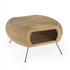 a small wicker ottoman with metal legs and a cushion on the top, in front of a white background