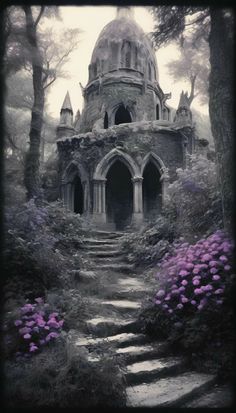 an old building in the middle of a forest with stairs leading up to it and purple flowers growing on the ground