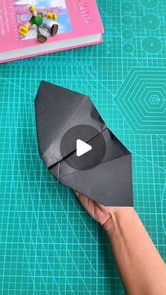 someone is making an origami airplane out of paper