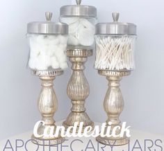 three candlesticks with white cotton in them