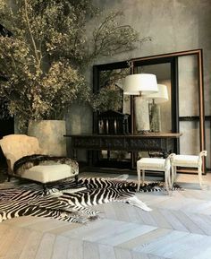 a living room with zebra print rugs and an animal - print chair in front of a mirror