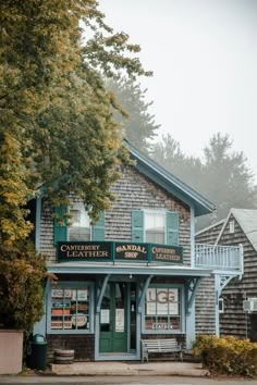 an old building with many signs on the front and side of it, along with trees