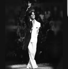 elvis presley waves to the crowd as he performs on stage