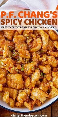 a bowl filled with fried chicken on top of a wooden table