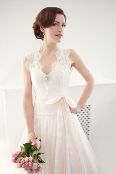 a woman in a wedding dress holding a bouquet