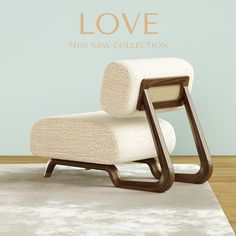 a white chair sitting on top of a rug in front of a wall with the words love