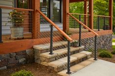 a house with stone steps and metal railings