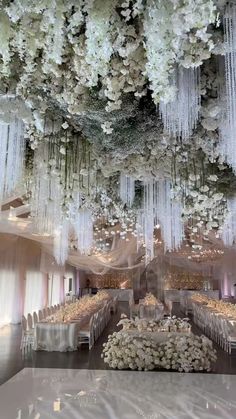 the ceiling is decorated with white flowers and icicles hanging from it's ceiling