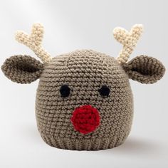 a crocheted stuffed animal with a red nose and antlers on it's head