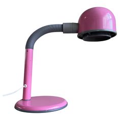 a pink desk lamp on a white background