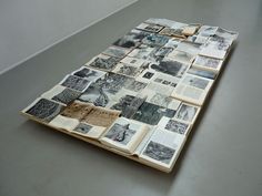 an open book laying on top of a table covered in pictures