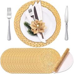 a table setting with place settings, napkins and silverware on white plate covers