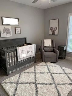 a baby's room with gray walls and white carpet