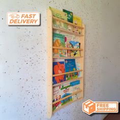 a wall mounted wooden book rack on the side of a wall with fast delivery stickers