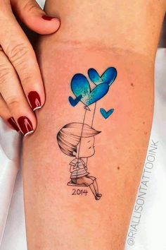 a woman's leg with a blue balloon and heart shaped balloons tattoo on it