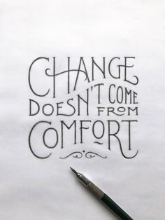 a pen sitting on top of a piece of paper that says change doesn't come from comfort