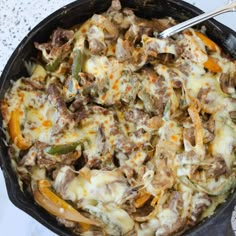 a skillet filled with cheese and vegetables